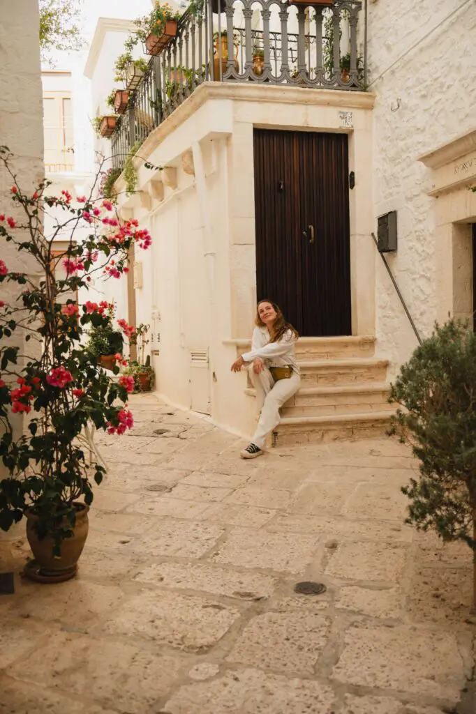 woman sitting on steps in Locorotondo