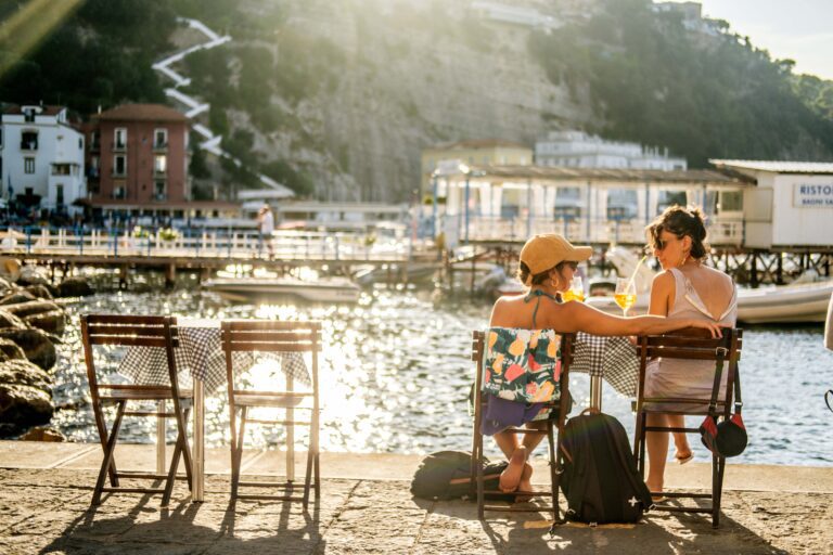 two friends drinking Aperol Spritz in Italy